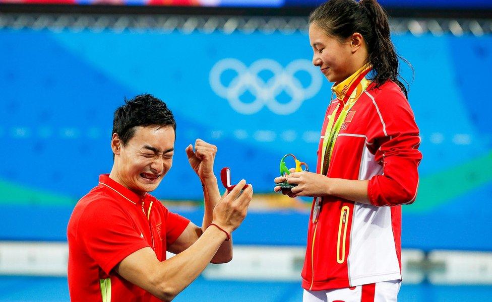 He Zi (R) of China receives a marriage proposal from Chinese diver Ki Qin (L) after winning the silver medal in the women"s 3m Springboard final of the Rio 2016 Olympic Games Diving events