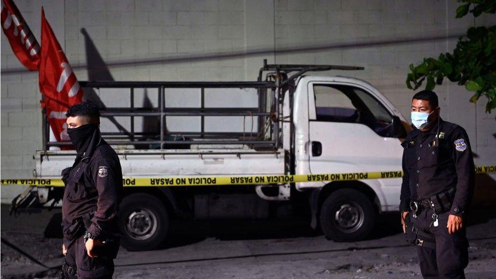 Police guard a truck that carried supporters of the political party Farabundo Marti Front (FMLN)