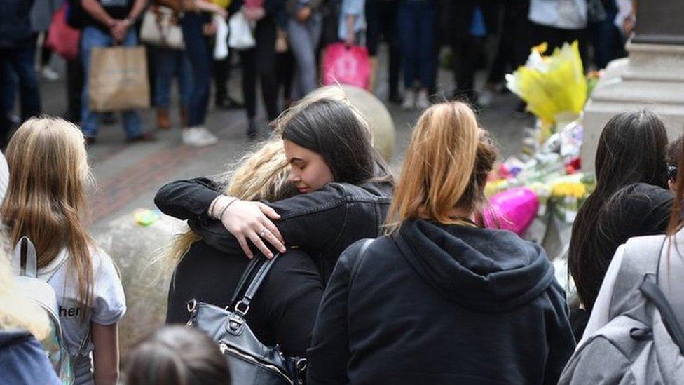 Two women hug during minute's silence