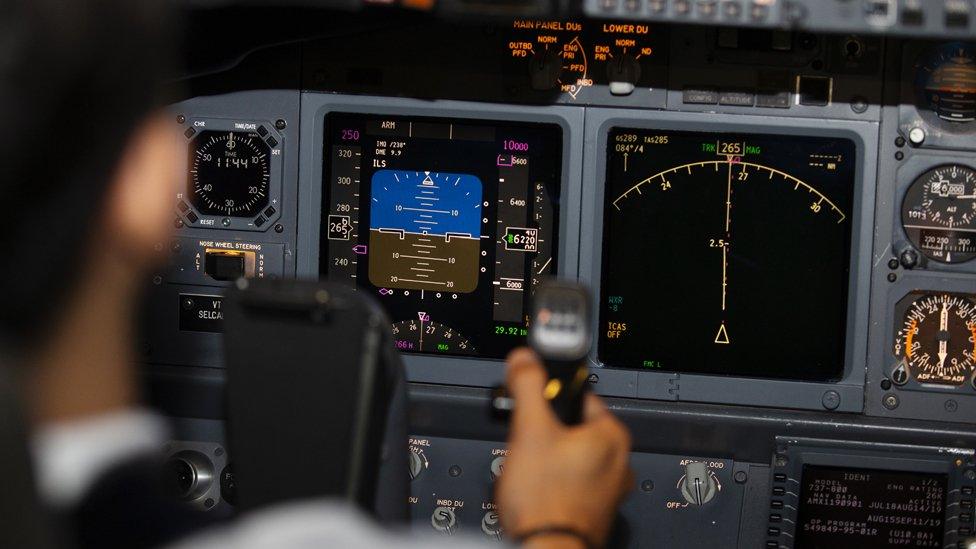 A man performs a test flight in a CAE Inc. 7000 Series Boeing Co. 737-800 flight simulator