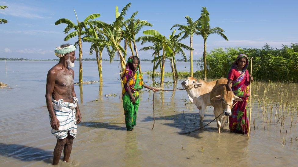 Family in floodwater in Bangladesh