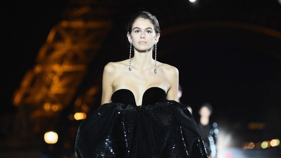 Kaia Gerber walks the runway during the Saint Laurent show