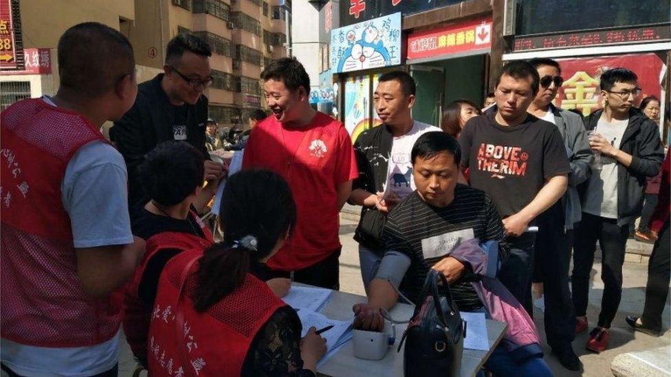 Locals give blood in Yulin city in China where nine schoolchildren were stabbed to death, 28 April 2018