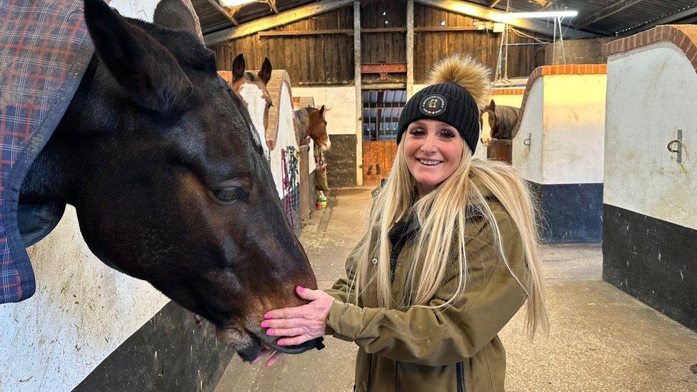 Kelly Harrop with one of the horses she looks after