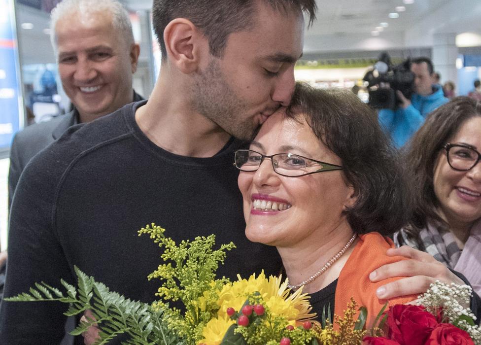 Homa Hoodfar gets a kiss from her nephew as she arrives at Trudeau airport