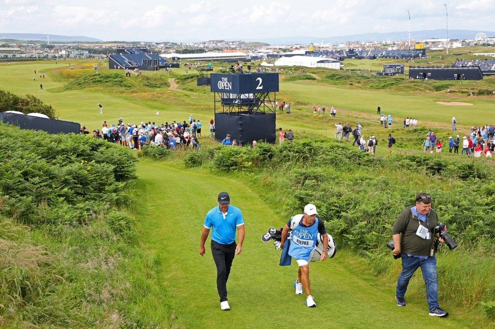 Brooks Koepka and Ricky Elliott walk away from the second hole at Royal Portrush