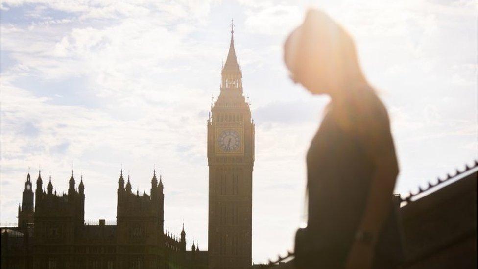 People walk near the Palace of Westminster