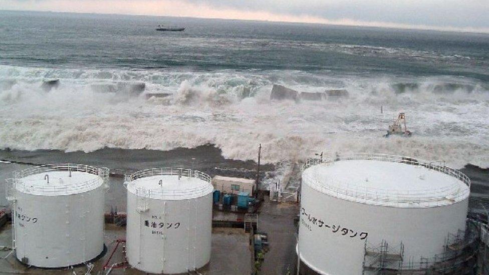 Waves breaching the sea wall of the Fukushima power plant, March 2011