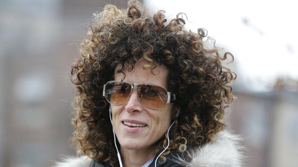 Andrea Constand walks in a park wearing headphones in Toronto, December 30, 2015.