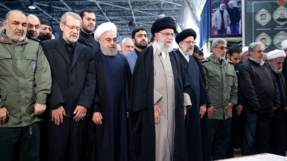 Iran's Supreme Leader Ayatollah Ali Khamenei and Iranian President Hassan Rouhani pray near the coffin of Qasem Soleimani alongside other officials in Tehran, 6 January 2020