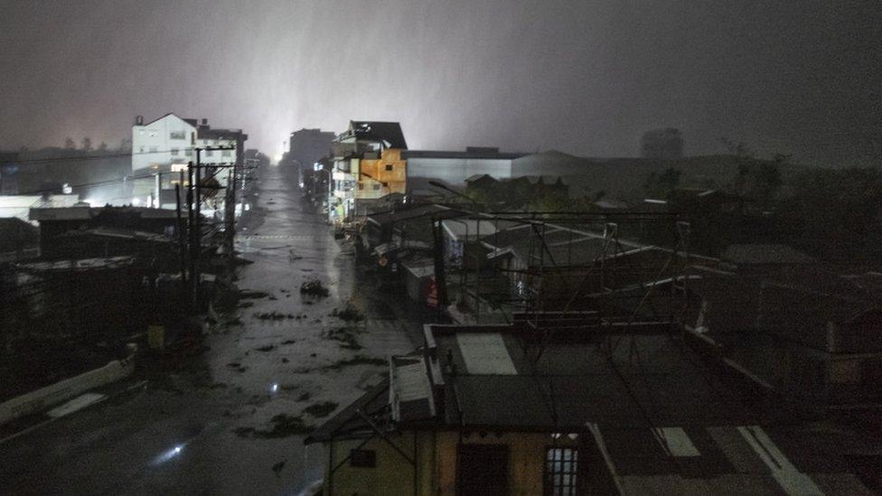 Dark skies and heavy rain pictured in the city of Tuguegarao, in the north-east