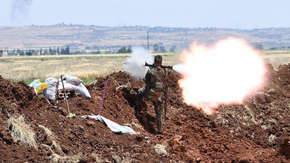 Syrian pro-government fighter fires a rocket-propelled grenade towards opposition fighters in northern Hama province, Syria (28 May 2019)