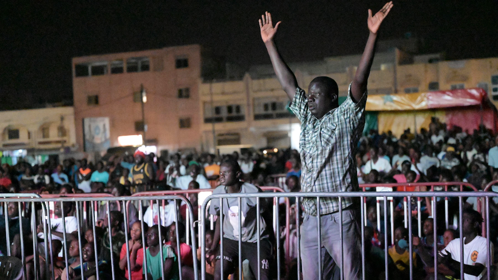 Senegalese watch a live broadcast of the Qatar 2022 World Cup Football semi-final match between Morocco and France at Parcelles Assainie in Dakar on 14 December 2022