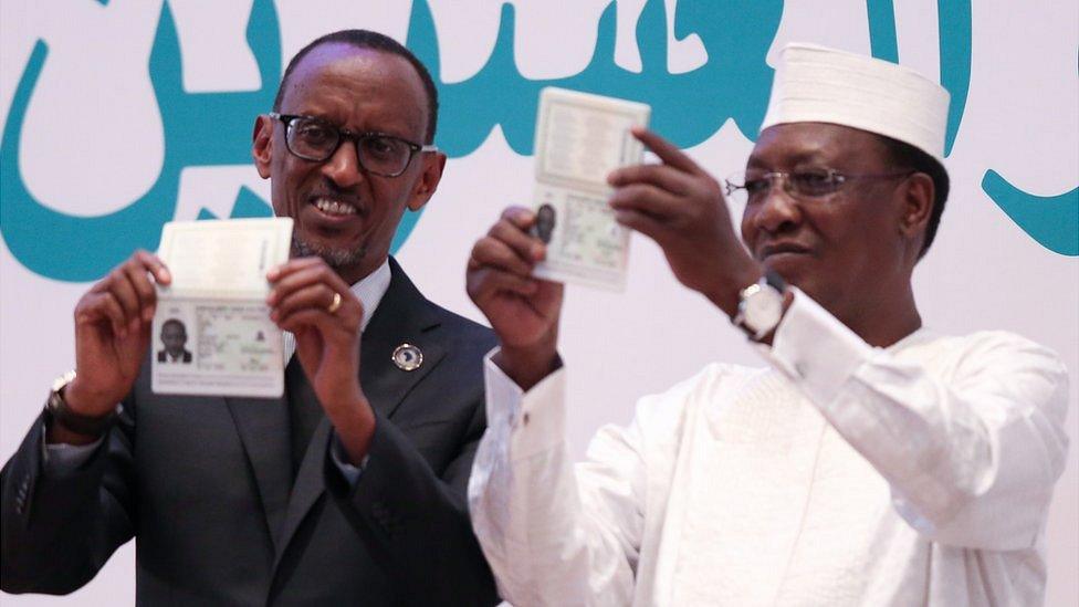 Idriss Deby (R), President of the Republic of Chad, and President of Rwanda Paul Kagame show their e-passports at the opening ceremony 27th ordinary session of the AU Heads of States, Kigali, Rwanda