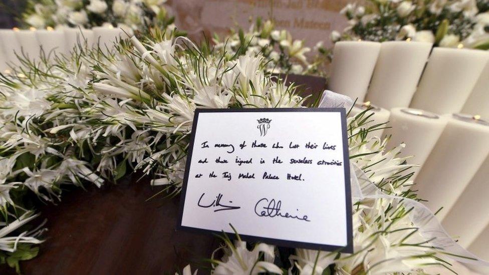 Close-up of wreath laid by royals and message