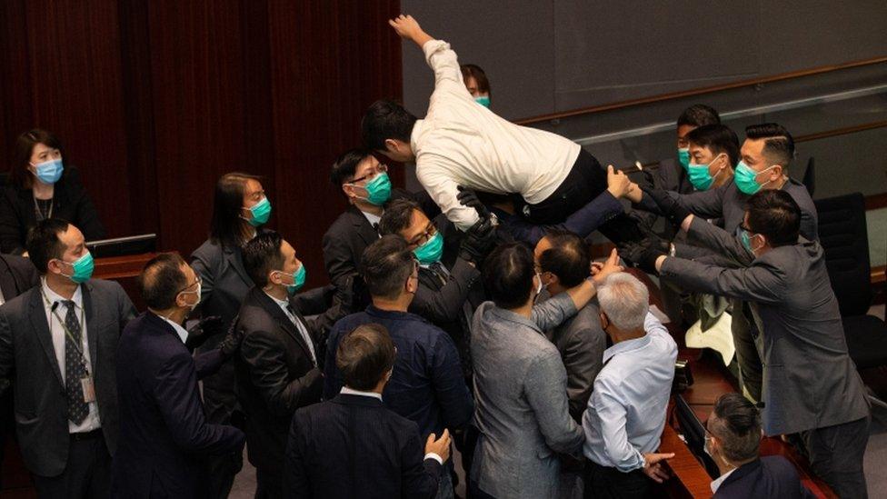 Pro-democracy lawmaker Ted Hui tried to jump onto the chairman's bench