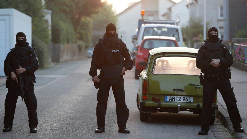 Special police officers secure a street near the house where a Syrian man lived before the explosion in Ansbach, southern Germany, Monday, July 25, 2016