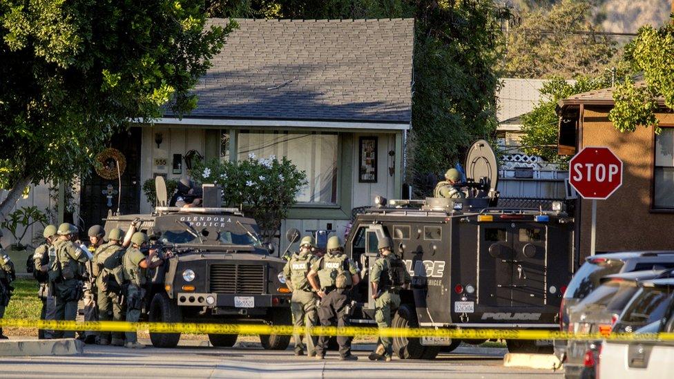 SWAT team moves in on a barricaded suspect on Fourth Street east of Orange Avenue after several people were shot at that location in Azusa, Calif.