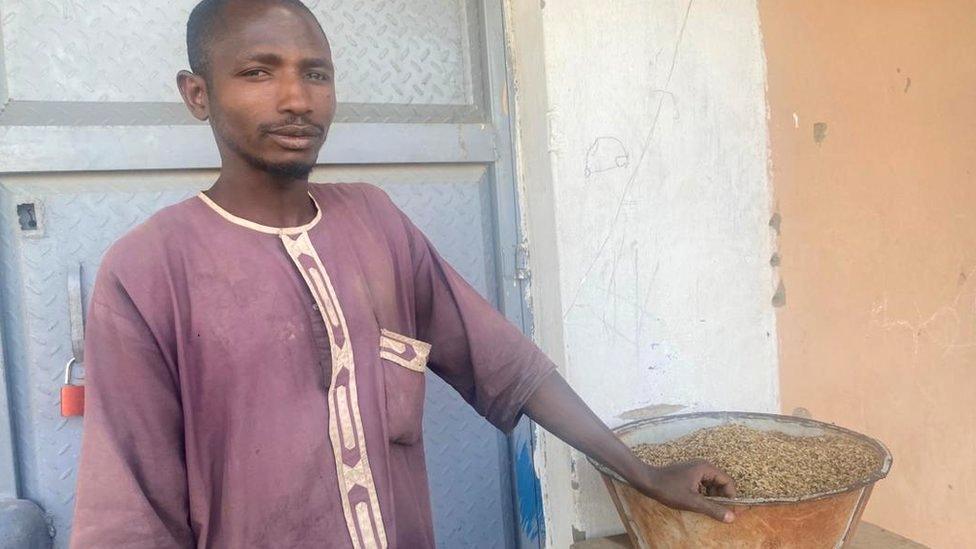 Man standing next to a bowl of rice