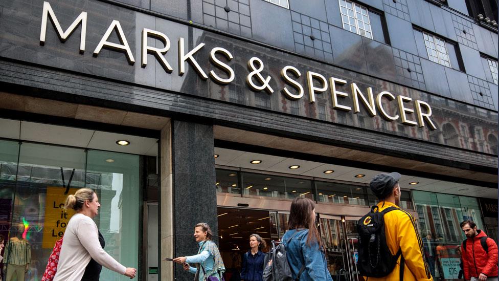 Shoppers walk past a Marks and Spencer store on Oxford Street, London