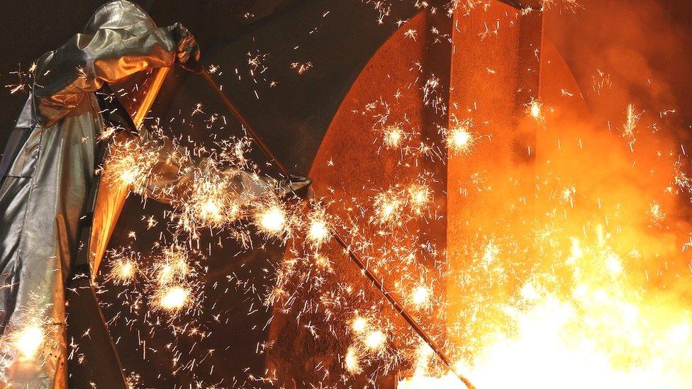 an employee takes a sample at the blast furnace at the ThyssenKrupp plant in Duisburg