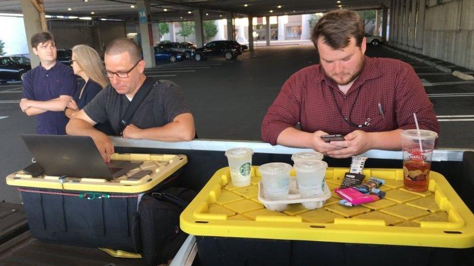 Capital Gazette reporter Chase Cook (R) and photographer Joshua McKerrow (L) work on the next days newspaper while awaiting news from their colleagues in Annapolis, Maryland, on 28 June 2018.