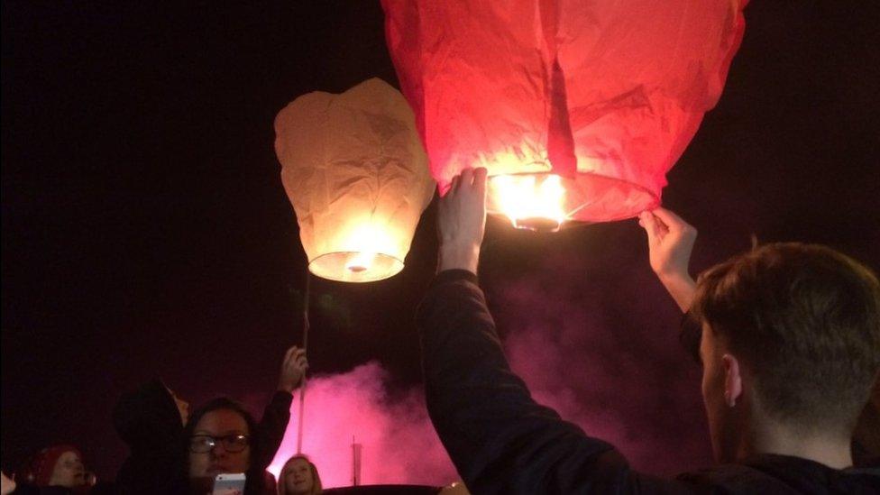 Lanterns being lit at the vigil