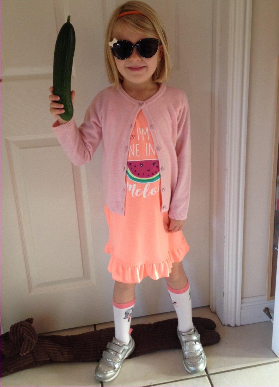 Maya is going to school dressed as Sophie from the BFG holding her snozzcumber