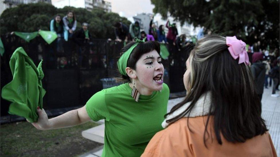 A pro-choice activist (L) argues with a woman opposed to the legalisation of abortion outside the Argentine Congress in Buenos Aires, on 13 June 2018.