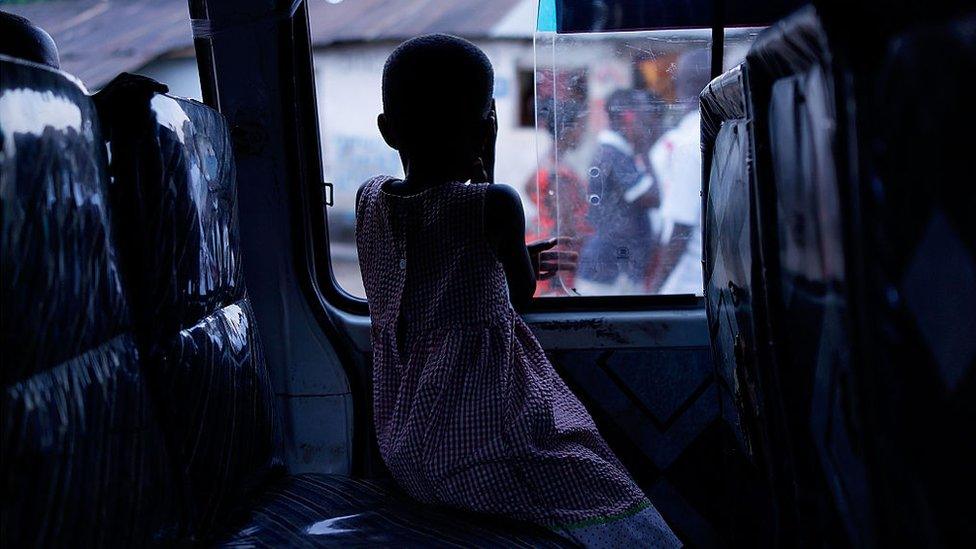 A girl waits in a van as her family packs-up to leave the capital as tension increases before parliamentary elections on Monday on June 27, 2015 in Bujumbura, Burundi