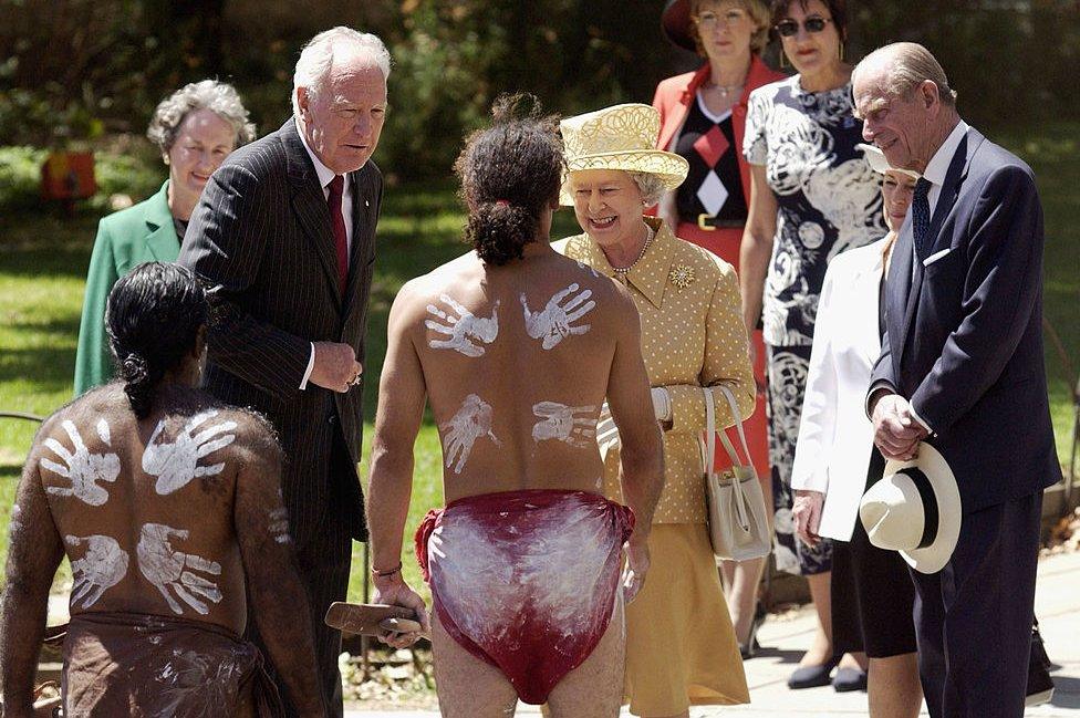 Queen Elizabeth II and her husband Prince Philip The Duke of Edinburgh, and their representative in Australia Governor-General Peter Hollingworth meet aboriginal dancers from the Paitya Dance Group during a ceremonial welcome to mark the beginning of the Royal visit to Australia, 27 February 2002 in Adelaide.