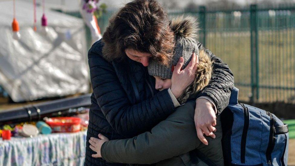 A family reunites at the Medyka border crossing, after crossing the Ukrainian-Polish border