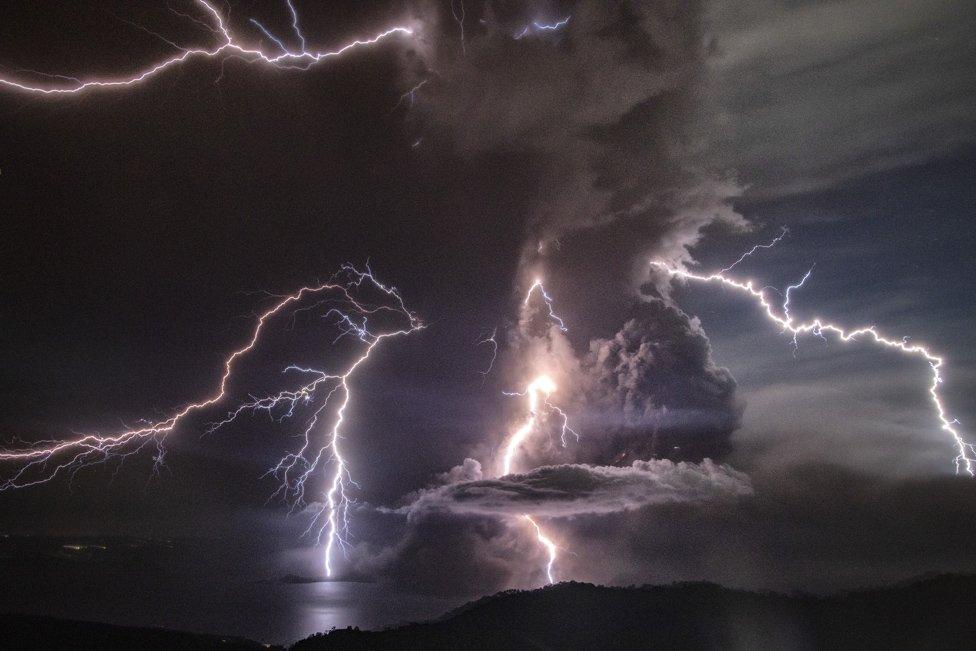 Lightning strikes as a column of ash surrounds the crater of Taal Volcano as it erupts on January 12