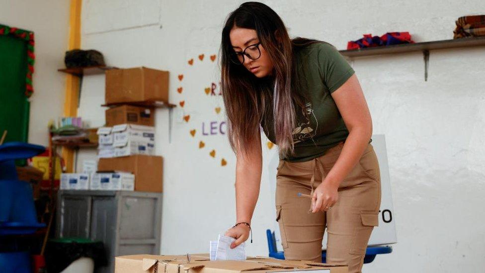 A woman takes part in a referendum that asks voters to support mostly security-related questions to fight rising violence, in Quito, Ecuador April 21, 2024