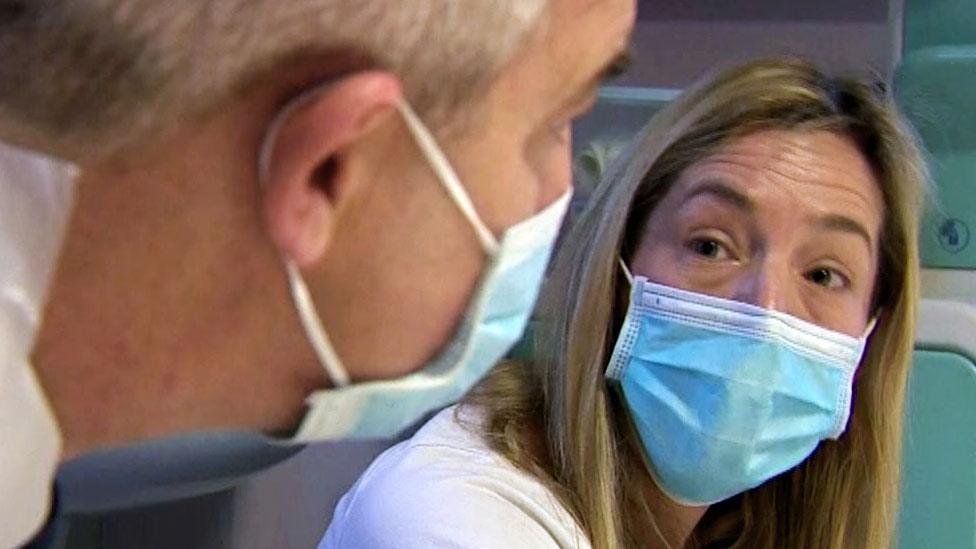 Woman and Steve Barclay in conversation, wearing face masks