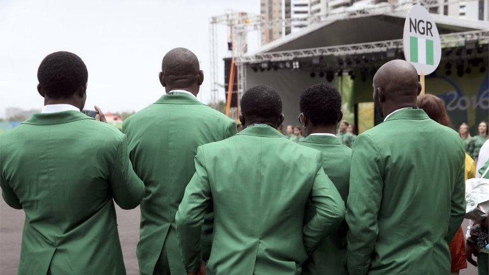 Athletes from Nigeria stand together in the Olympic village