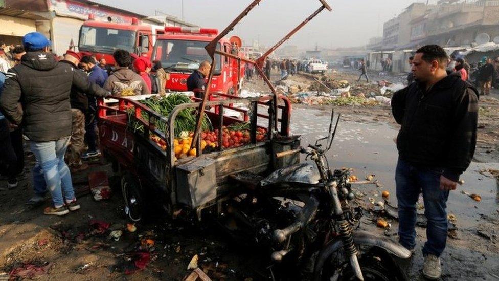 Scene of a suicide car bomb blast at a market in Baghdad, 8 January 2017