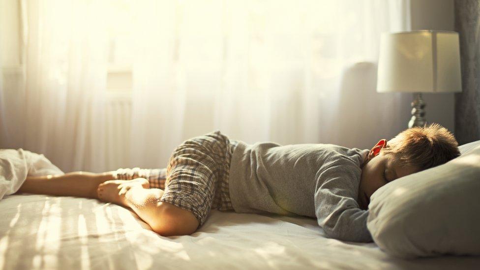 Boy aged 6 sleeping in a bed