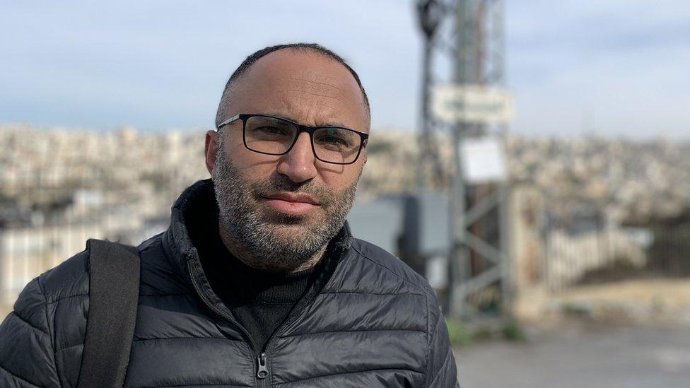 Issa Amro stands on street