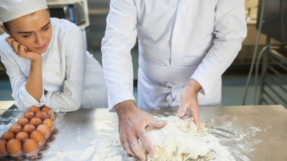 Girl watches baker at work