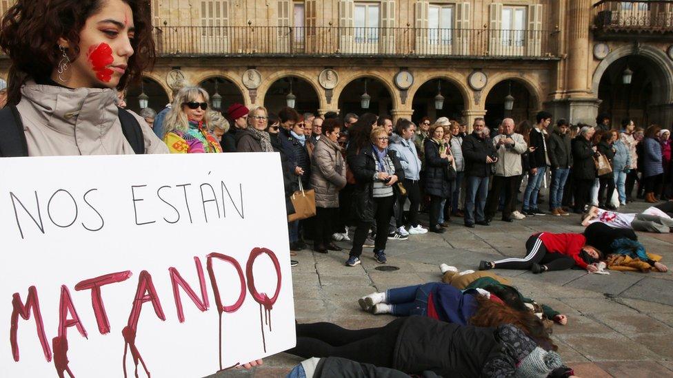 A demonstrator holds a banner reading "They are killing us", as several Fine Arts College students stage a rally in memory of murdered Spanish teacher Laura Luelmo, in Salamanca, northern Spain, 19 December 2018