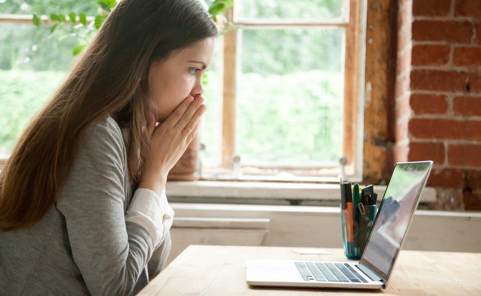 Woman looking at laptop