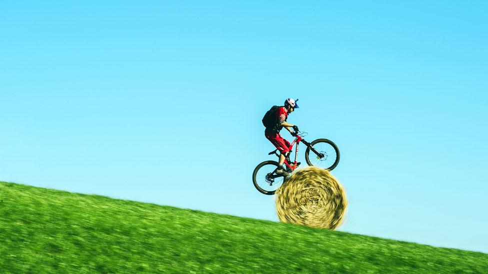 Danny MacAskill on a round straw bale