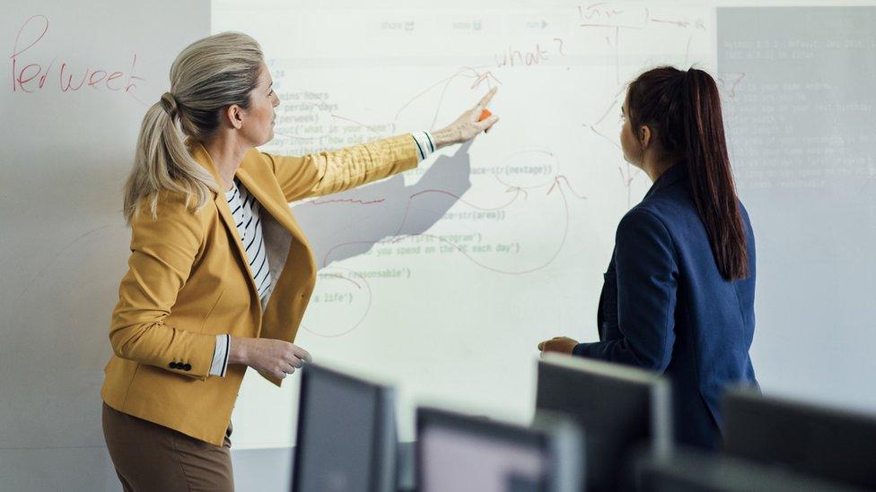 Teacher and pupil at whiteboard