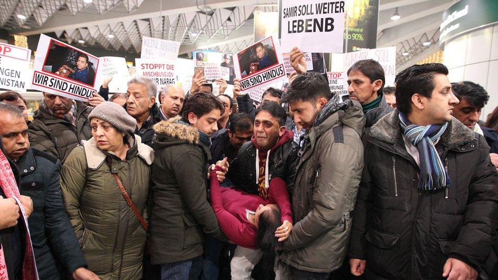 Demonstrators protest against the deportation of refugees back to Afghanistan at the airport in Frankfurt/Main on December 14, 2016.