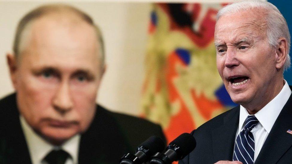 An image of Vladimir Putin is displayed as Joe Biden speaks about gas prices at the White House campus in June 2022