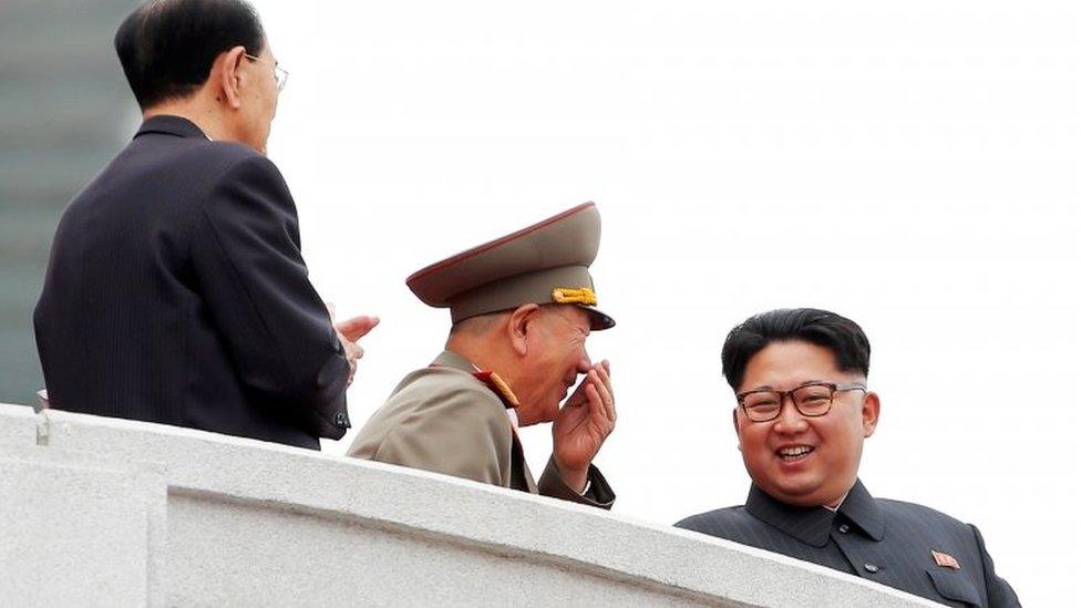 North Korean leader Kim Jong Un is accompanied by high party and military officials as he presides over a mass rally and parade in Pyongyang