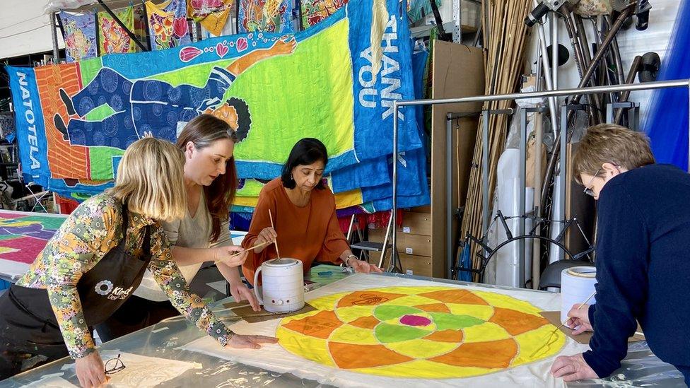 People painting giant scrolls