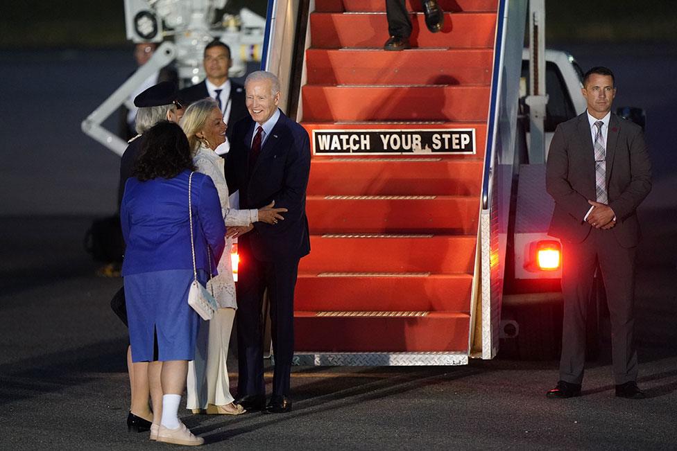 US President Joe Biden is greeted by Jennifer Tolhurst, Lord-Lieutenant of Essex, Jane Hartley, US Ambassador to the United Kingdom and Karen Pierce, British Ambassador to the United States, after arriving on Air Force One at Stansted Airport in Essex, on 9 July 2023