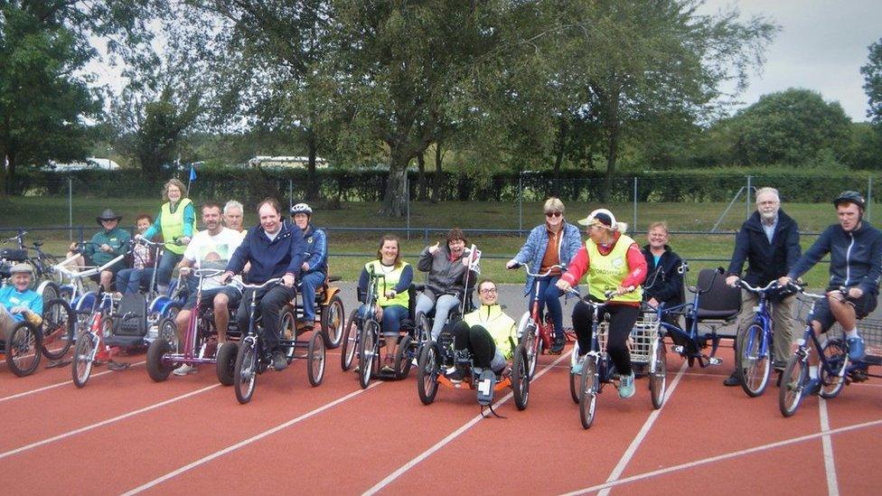 A group of people on bikes at a cycling track